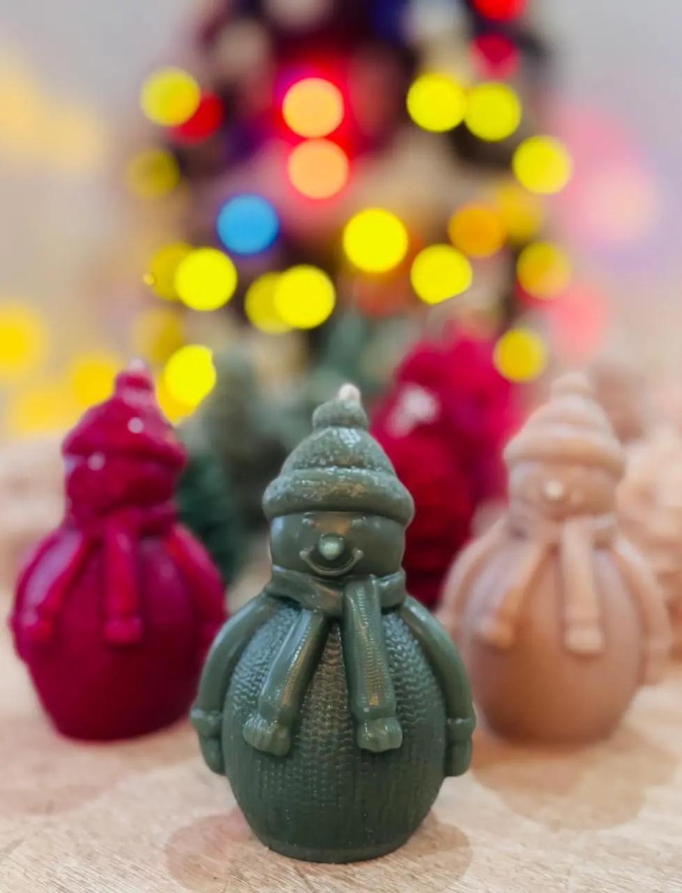 Red, green and nude candles of snowmen.