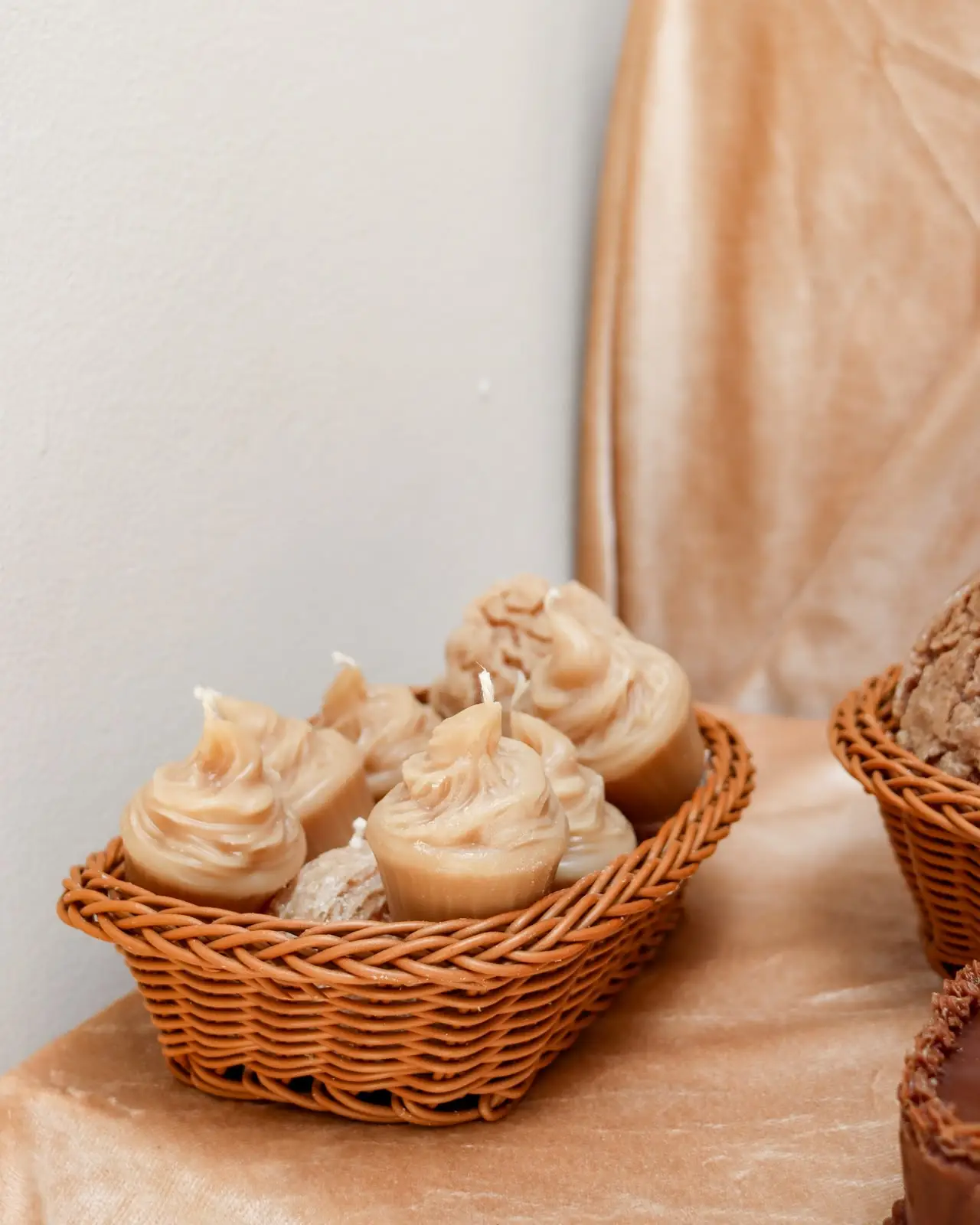 Brown cupcake candles in a basket.